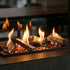 Fireplace with burning logs and flames in a dark setting