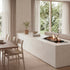 Modern living room with a fireplace, dining table, and chairs.